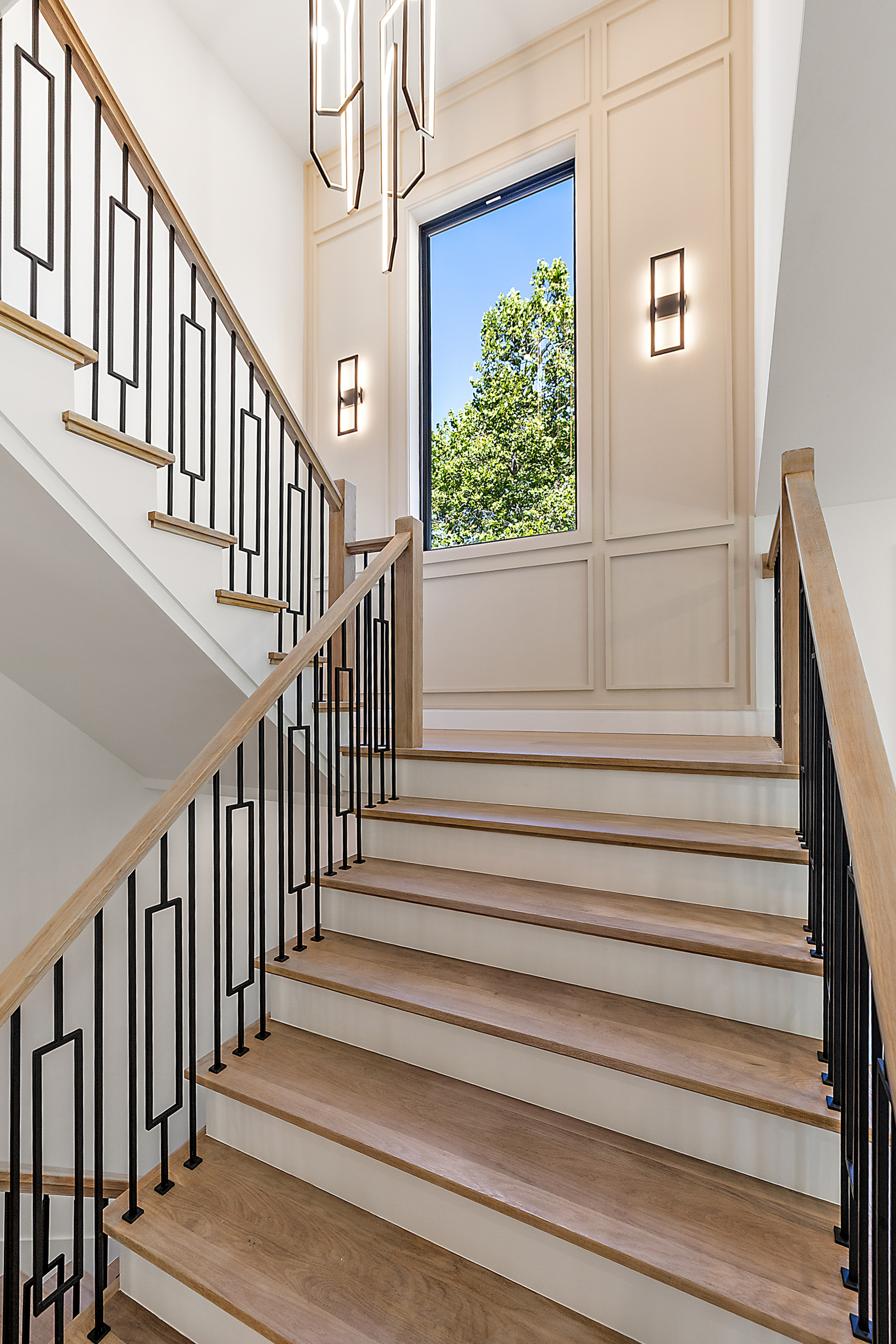 White oak staircase with geometric black metal balusters